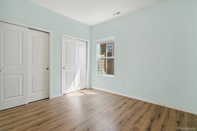 8339 Mosby Way, Colorado Springs, CO 80908 - unfurnished bedroom with two closets and wood finished floors