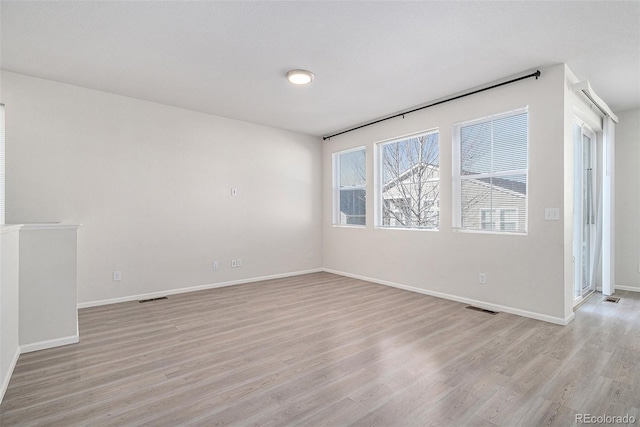 unfurnished room with light hardwood / wood-style flooring