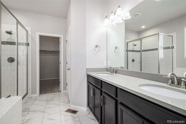 7285 S Titus Way, Aurora, CO 80016 - full bathroom featuring a shower stall, marble look tiles, a walk in closet, and double vanity