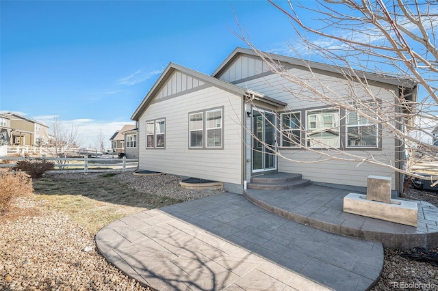 7285 S Titus Way, Aurora, CO 80016 - back of house featuring board and batten siding and a patio