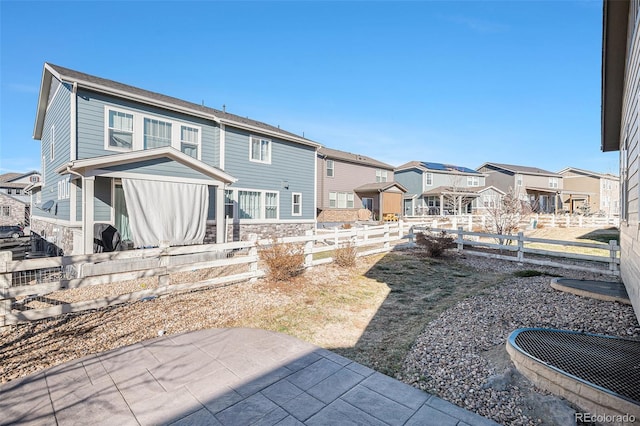 7285 S Titus Way, Aurora, CO 80016 - back of house featuring a residential view, stone siding, and a patio