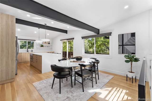 dining area featuring vaulted ceiling with beams, light hardwood / wood-style floors, and a wealth of natural light