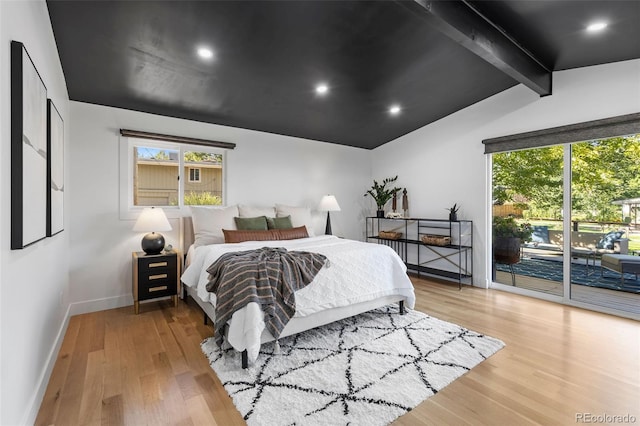 bedroom with access to exterior, vaulted ceiling with beams, and light hardwood / wood-style flooring