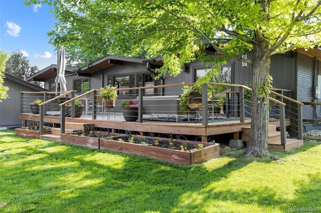 back of house featuring a yard and a deck