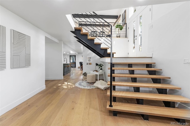 stairway with hardwood / wood-style flooring