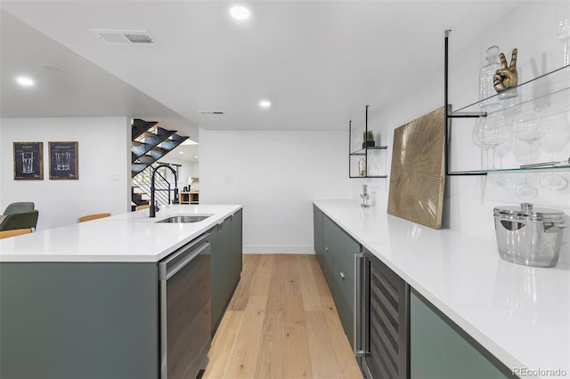 kitchen featuring light hardwood / wood-style flooring, beverage cooler, and sink