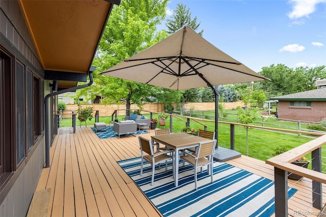 wooden terrace with a lawn and outdoor lounge area