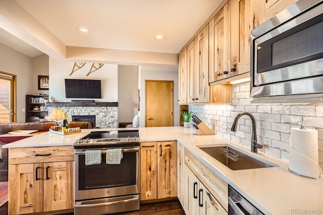 91400 Ryan Gulch Rd Unit 91427, Silverthorne, CO 80498 - kitchen featuring a sink, open floor plan, light countertops, a peninsula, and stainless steel appliances