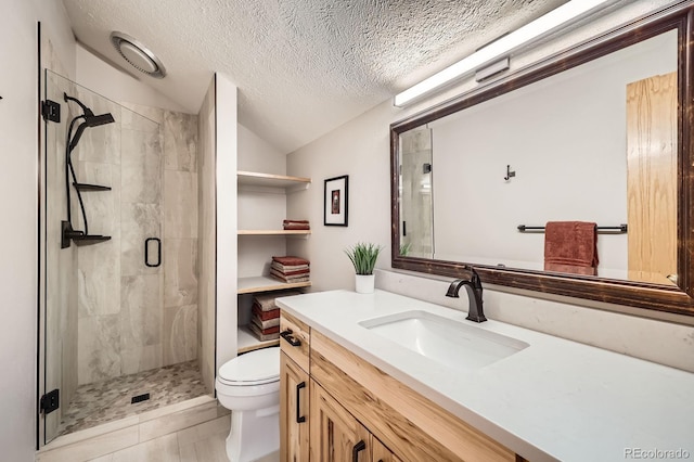 91400 Ryan Gulch Rd Unit 91427, Silverthorne, CO 80498 - full bathroom with a shower stall, a textured ceiling, vanity, vaulted ceiling, and toilet