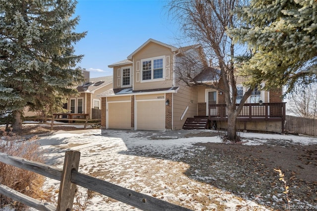 view of property featuring a garage and a wooden deck