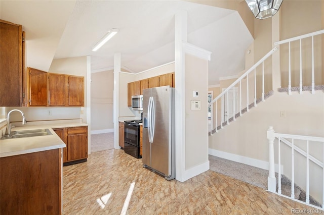 kitchen with lofted ceiling, appliances with stainless steel finishes, and sink