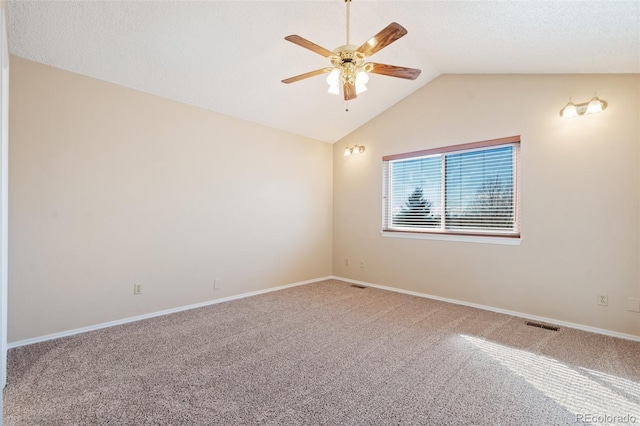 carpeted spare room with ceiling fan and lofted ceiling