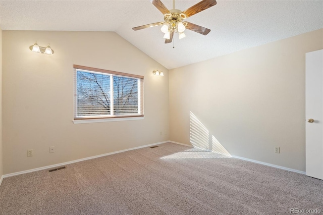 carpeted spare room featuring ceiling fan and vaulted ceiling