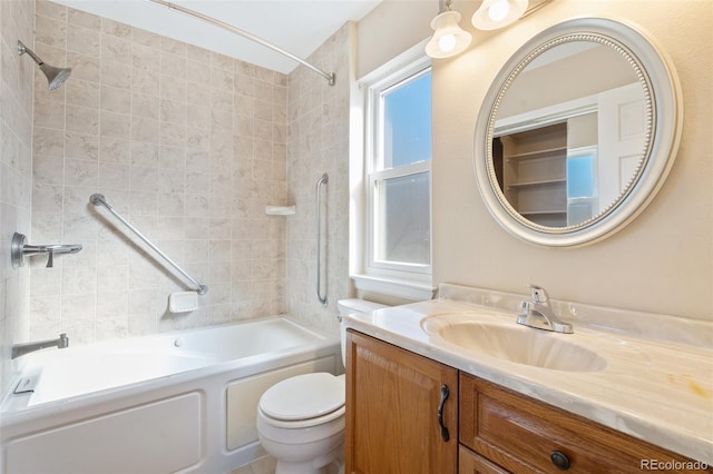 full bathroom with tiled shower / bath combo, vanity, and toilet