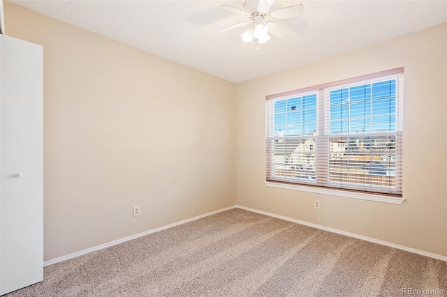 empty room with ceiling fan and carpet floors