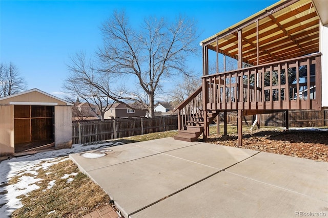 view of patio with a wooden deck and a shed