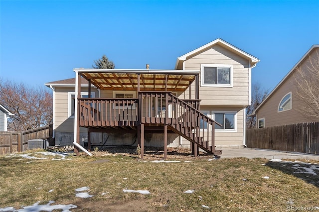 back of house with a lawn and a deck