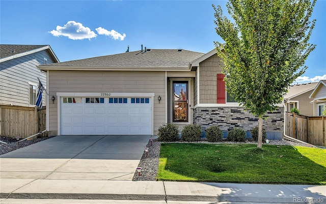 view of front of property featuring a garage and a front lawn