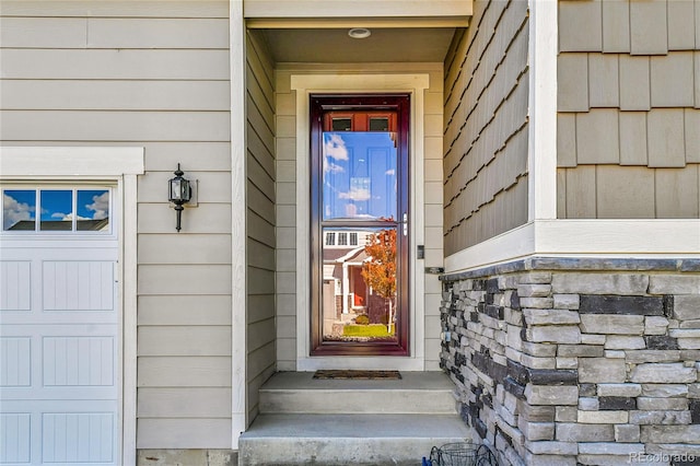 view of exterior entry featuring a garage