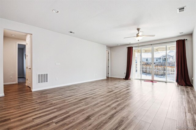 spare room featuring visible vents, baseboards, and wood finished floors