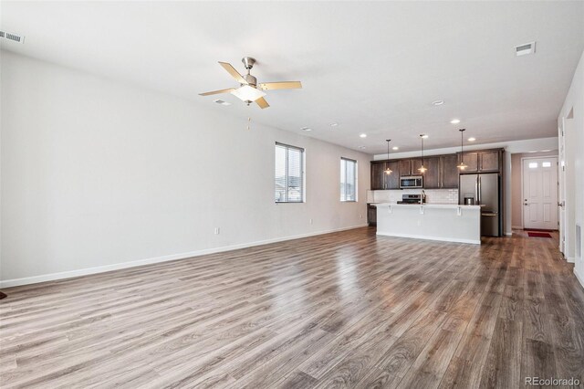 unfurnished living room featuring ceiling fan, recessed lighting, visible vents, baseboards, and light wood finished floors