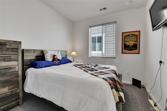 bedroom with carpet flooring, visible vents, and baseboards