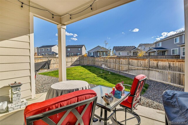 view of patio with a residential view, a fenced backyard, and area for grilling