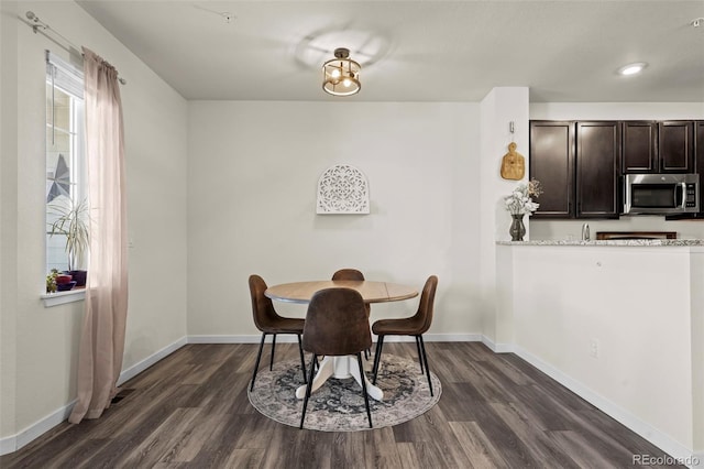 dining area featuring dark hardwood / wood-style flooring