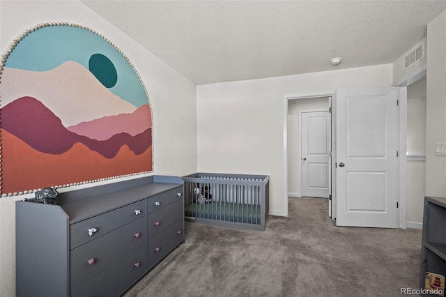 carpeted bedroom featuring a textured ceiling