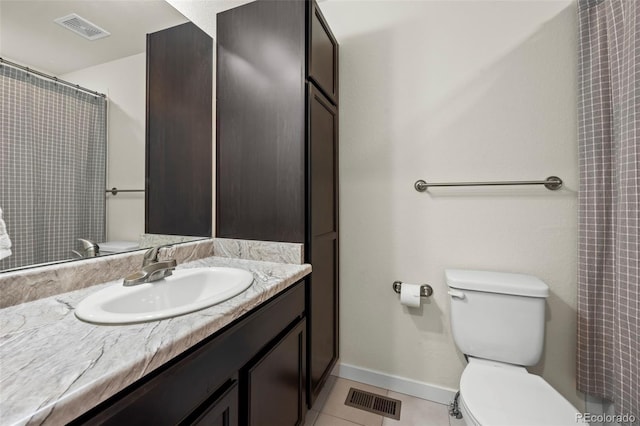 bathroom with vanity, walk in shower, tile patterned floors, and toilet