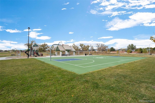 view of sport court featuring a lawn and a playground