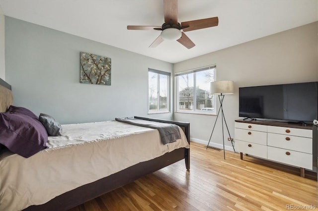 bedroom with ceiling fan and light wood-type flooring