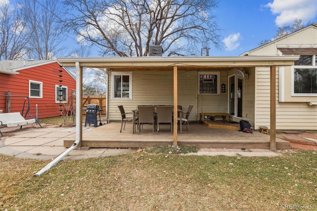 rear view of property featuring a yard and a deck