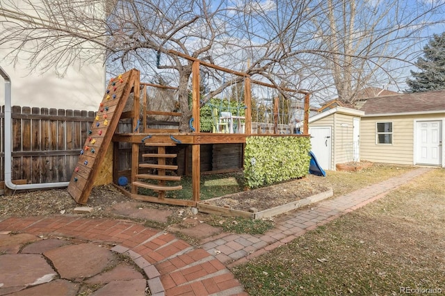 view of patio / terrace featuring a storage shed and a playground