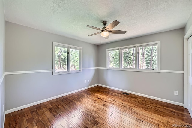 4776 Red Rock Dr, Larkspur, CO 80118 - unfurnished room with a textured ceiling, ceiling fan, hardwood / wood-style flooring, and baseboards