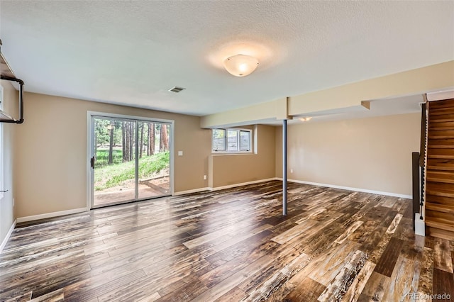 4776 Red Rock Dr, Larkspur, CO 80118 - unfurnished living room featuring wood finished floors, baseboards, and a textured ceiling