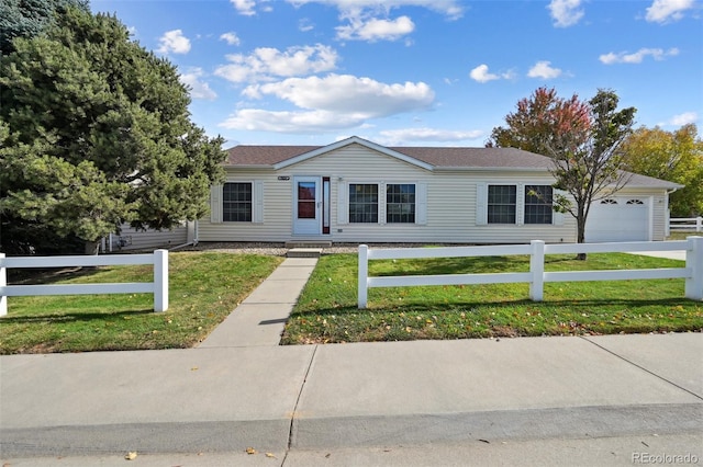 ranch-style home with a front lawn and a garage