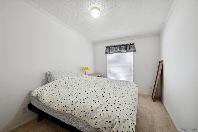 bedroom featuring light carpet, ornamental molding, and a textured ceiling