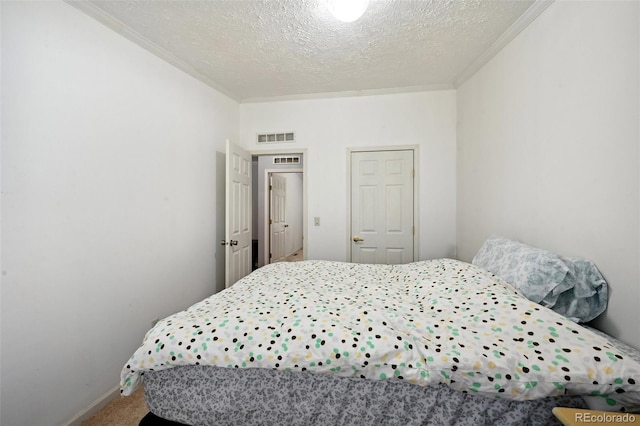 bedroom featuring a textured ceiling and carpet floors