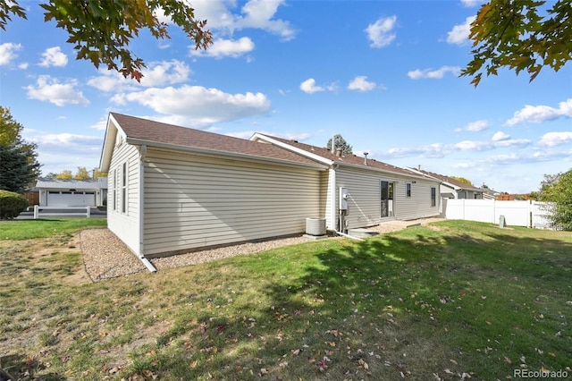 rear view of property featuring a lawn