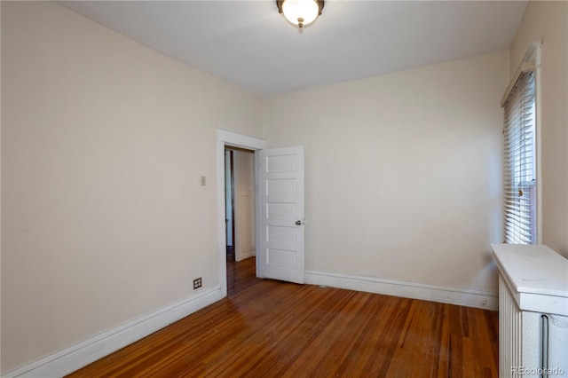 unfurnished bedroom featuring dark hardwood / wood-style flooring