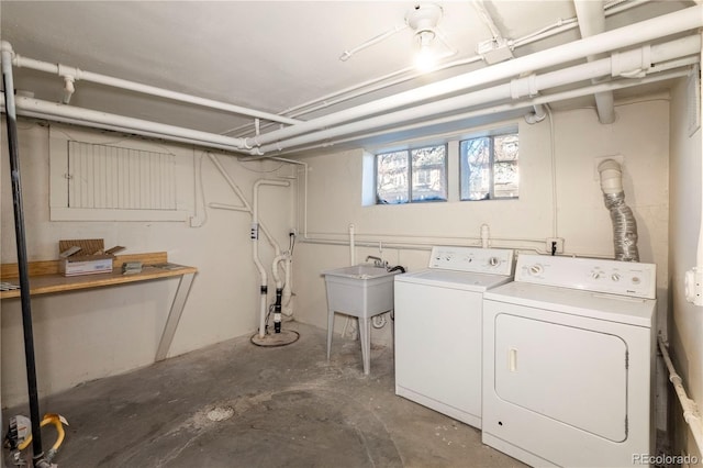 washroom featuring washer and clothes dryer and sink