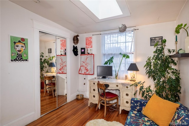 office with a skylight and hardwood / wood-style floors