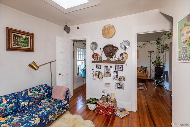 living room with a skylight and hardwood / wood-style flooring