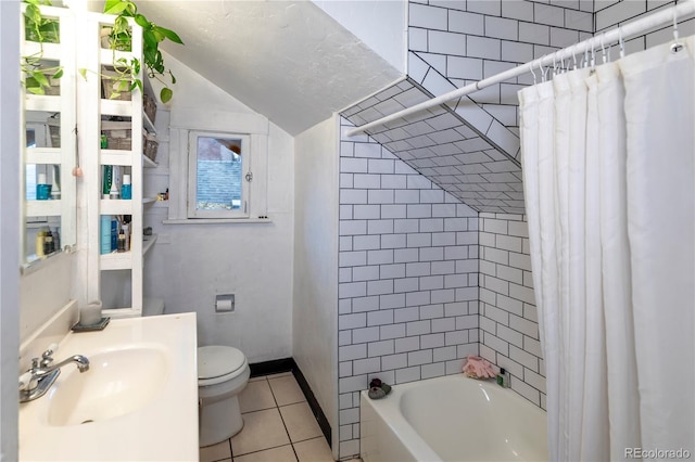 full bathroom featuring sink, shower / tub combo with curtain, lofted ceiling, tile patterned flooring, and toilet