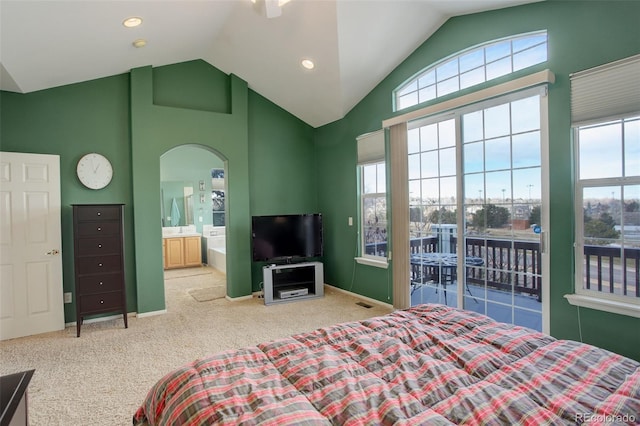 carpeted bedroom featuring access to outside, ensuite bath, and vaulted ceiling