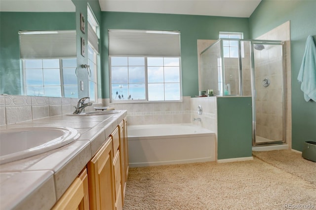 bathroom featuring vanity and shower with separate bathtub