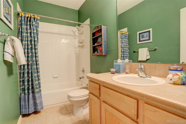 full bathroom featuring tile patterned flooring, vanity, toilet, and shower / tub combo with curtain