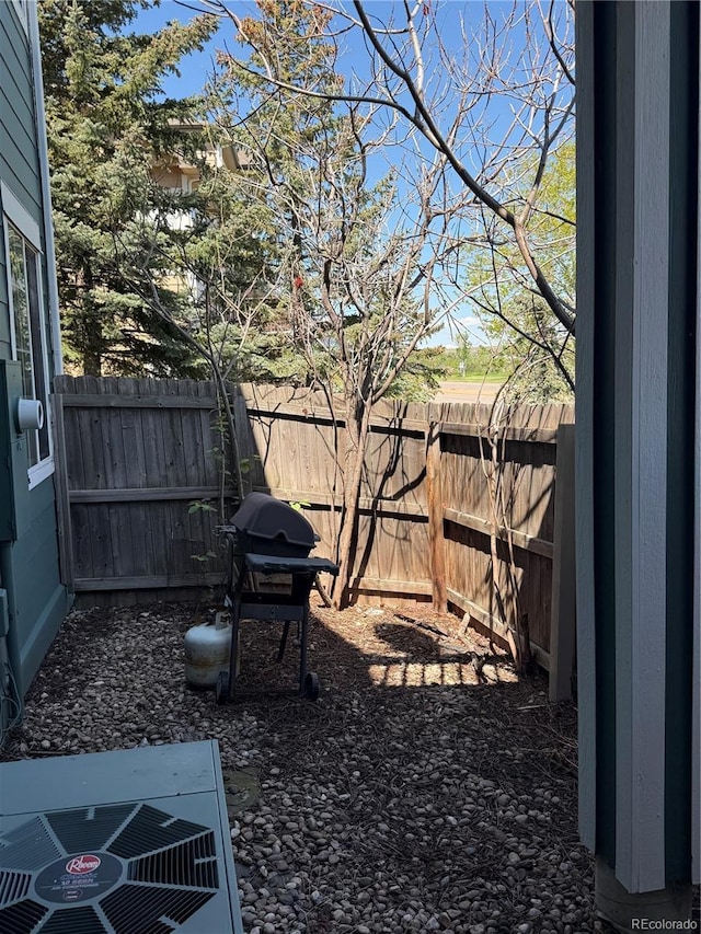 fenced backyard featuring central air condition unit