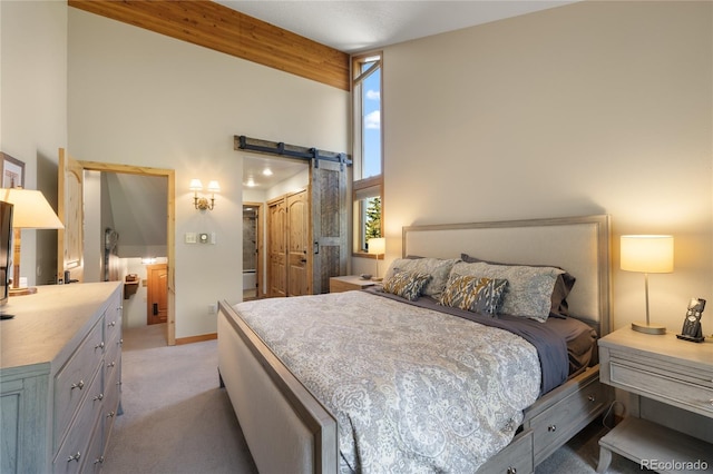 22300 US Highway 6 Unit 1746, Dillon, CO 80435 - bedroom featuring a barn door, light carpet, a high ceiling, a closet, and beam ceiling